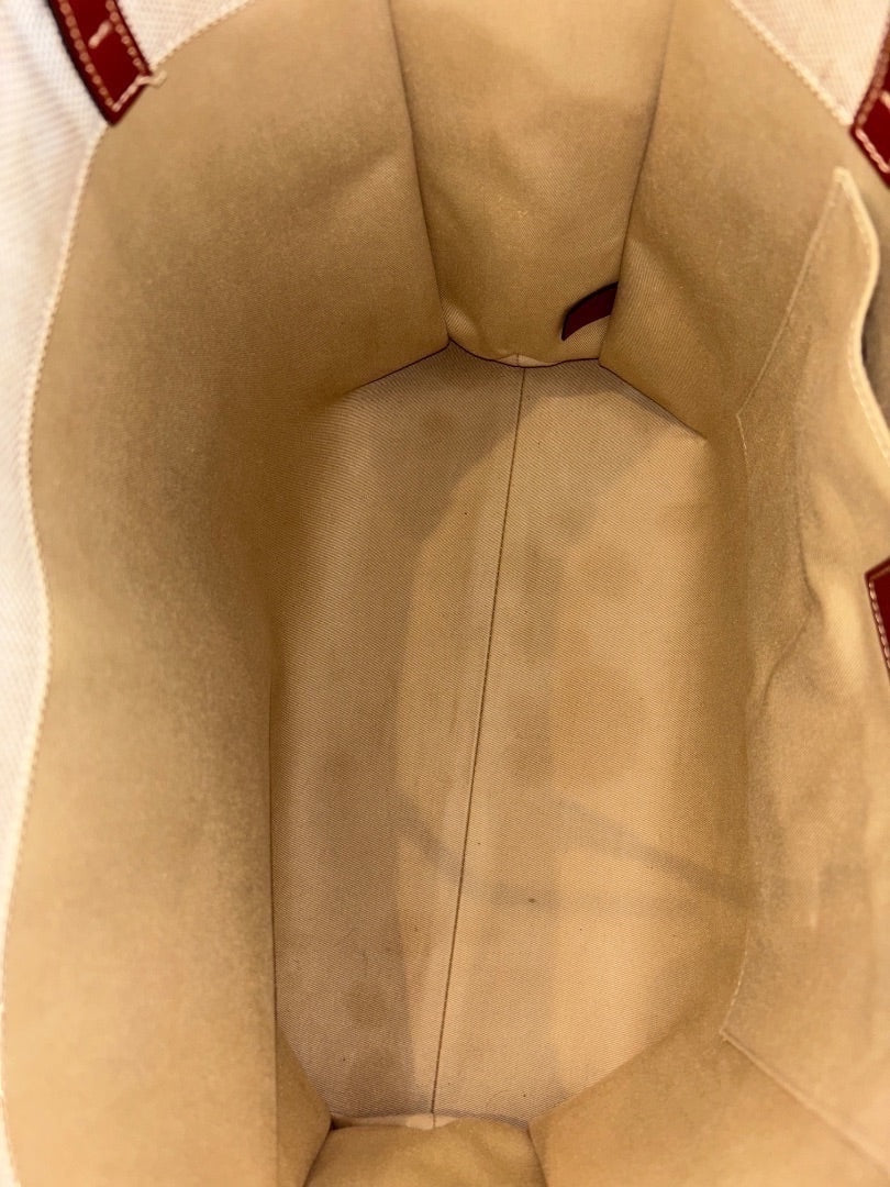 Interior of Posh Purse Co's beige Chloe Woody Large Tote bag made of canvas with red leather trim and logo straps.