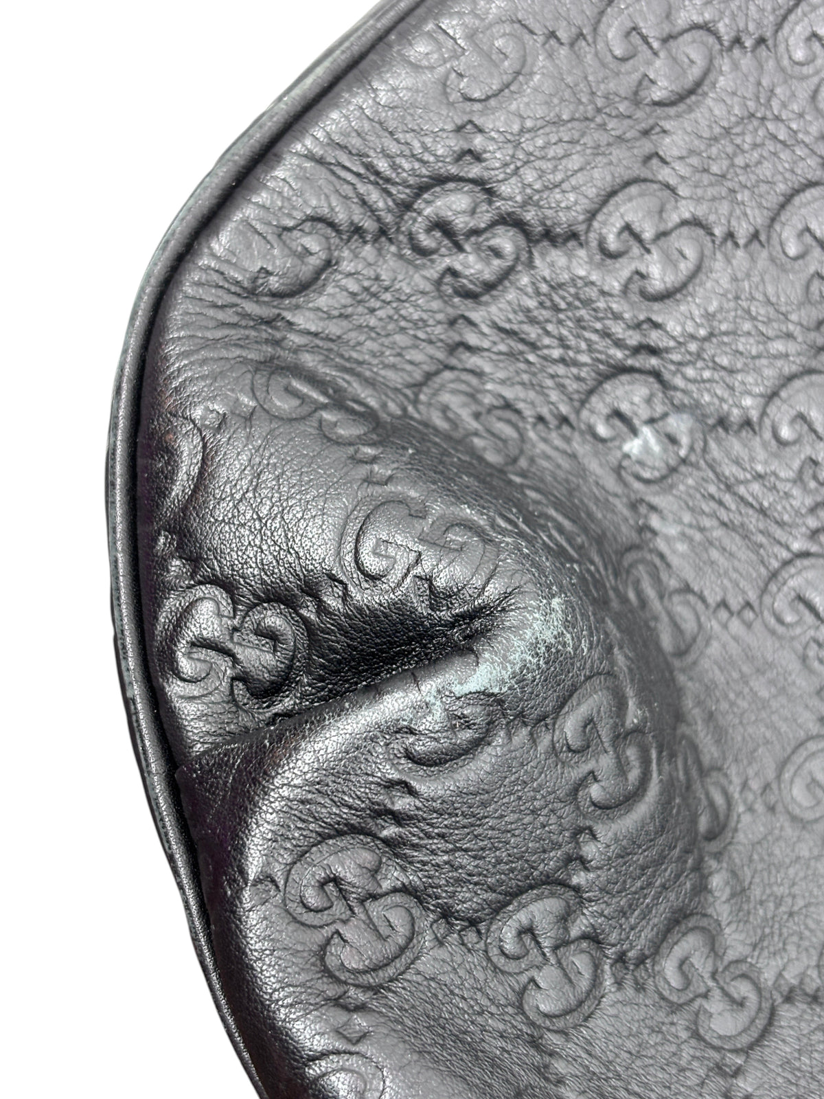Close-up of black embossed leather on a Posh Purse Co. Gucci Horsebit 1955 hobo bag showing the GG monogram pattern.
