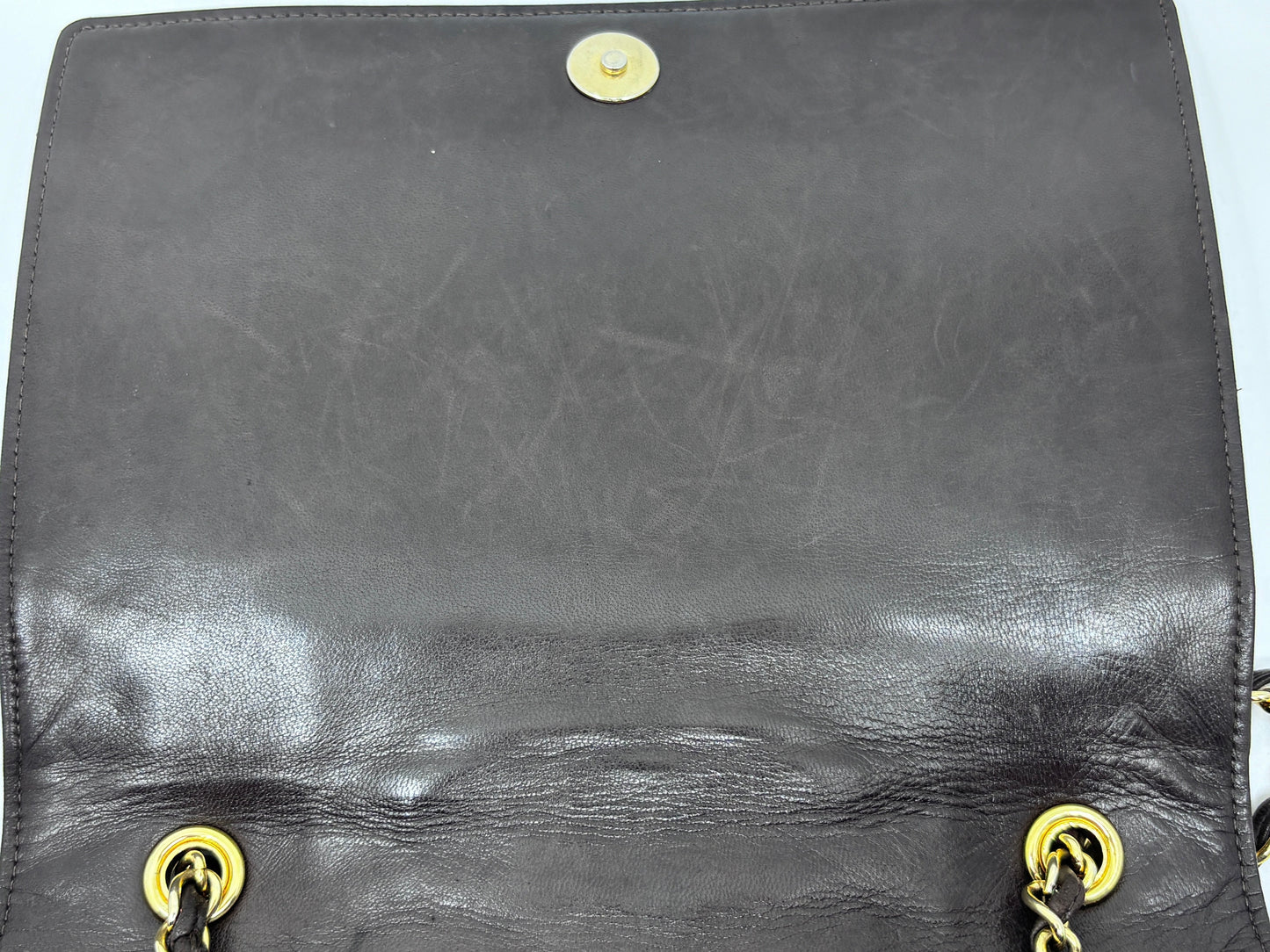 Posh Purse Co preloved brown Chanel Timeless Flap bag interior showing signs of wear and scratches on the leather