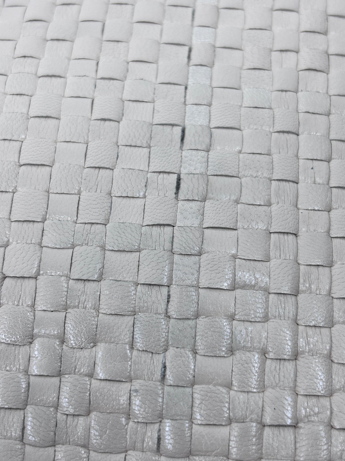 Close-up of the woven straw texture on a vintage Fendi crossbody bag from Posh Purse Co in a neutral beige tone.