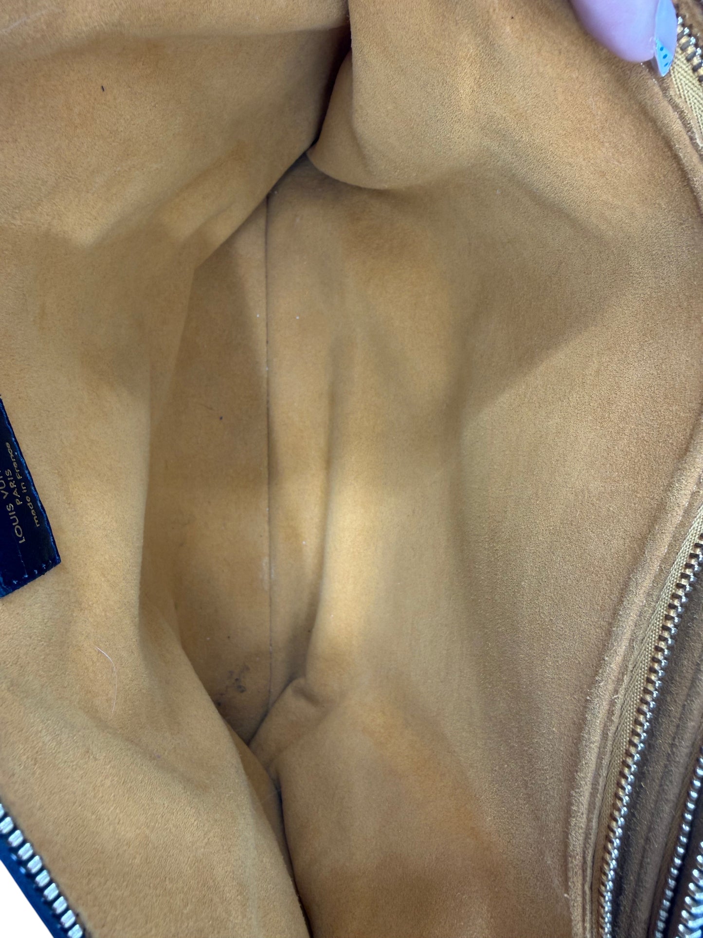 Interior view of Posh Purse Co preloved black Louis Vuitton Coussin MM bag showing tan suede lining and Louis Vuitton tag