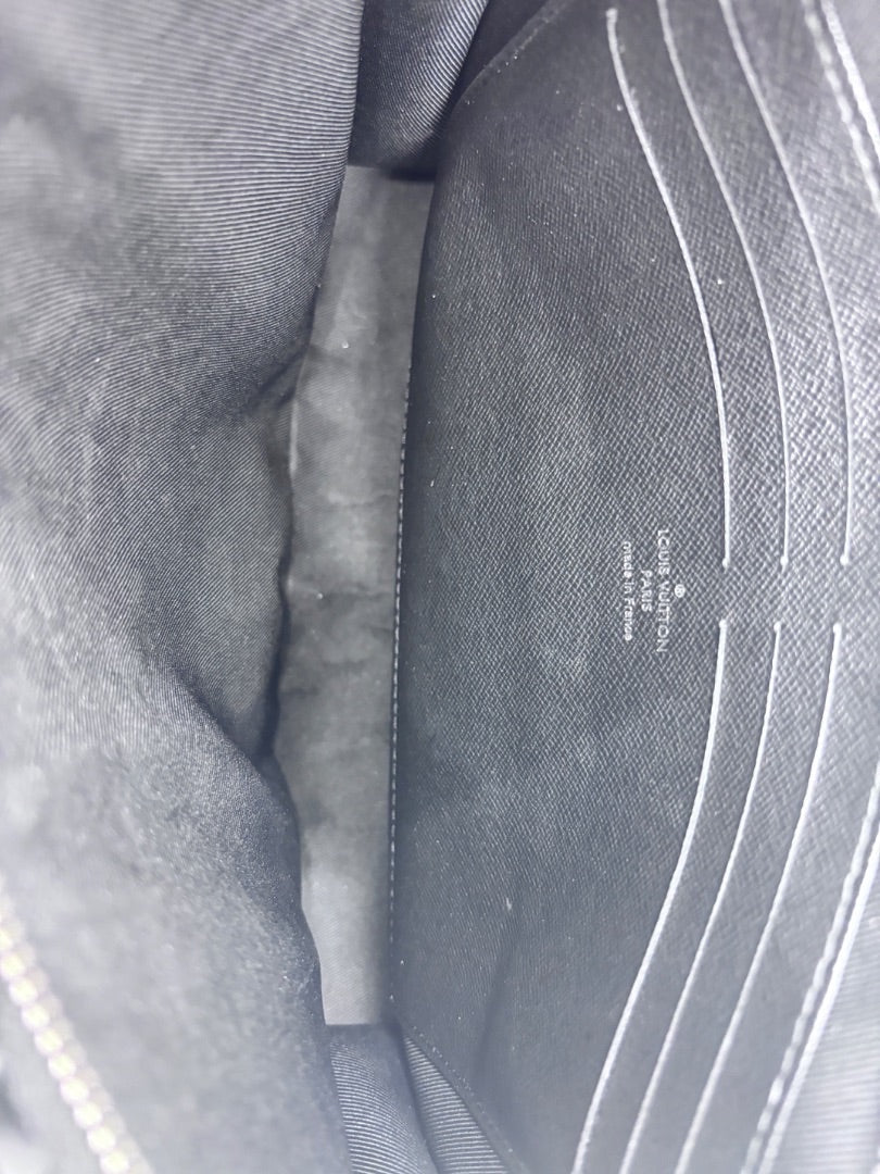 Interior of Posh Purse Co Louis Vuitton Pochette Voyage showing black fabric lining and card slots with embossed logo