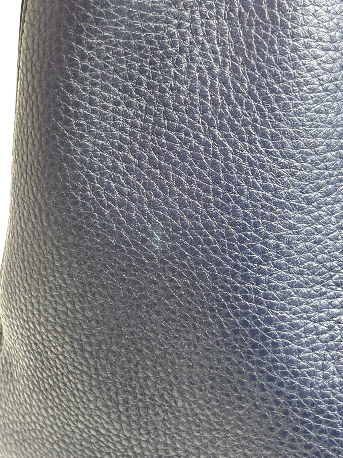 Close-up of navy blue grained calfskin leather texture on a Posh Purse Co Valentino Rockstud tote bag