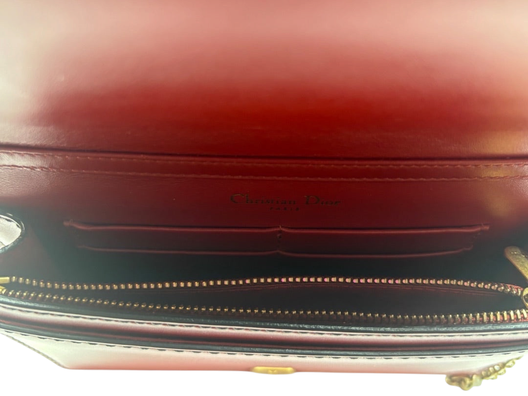 Interior of a red leather Dior J'adior crossbody bag with Christian Dior branding, available at Posh Purse Co.
