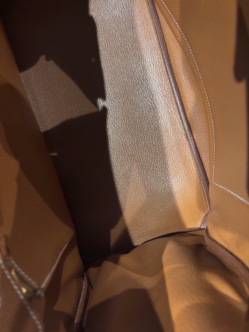 Posh Purse Co. Hermes Birkin 35 Togo leather handbag interior in classic gold color with gold hardware and white stitching.