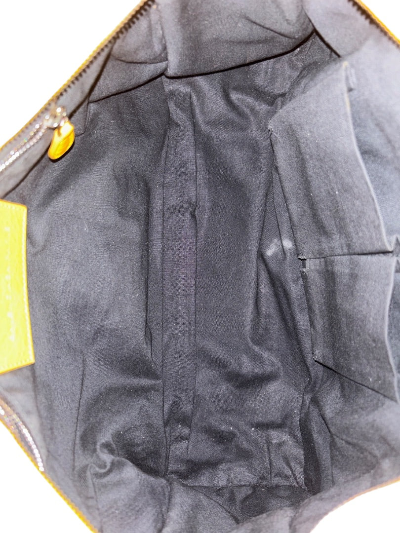 Posh Purse Co. yellow Balenciaga Agneau City Bag interior with black lining and pockets.