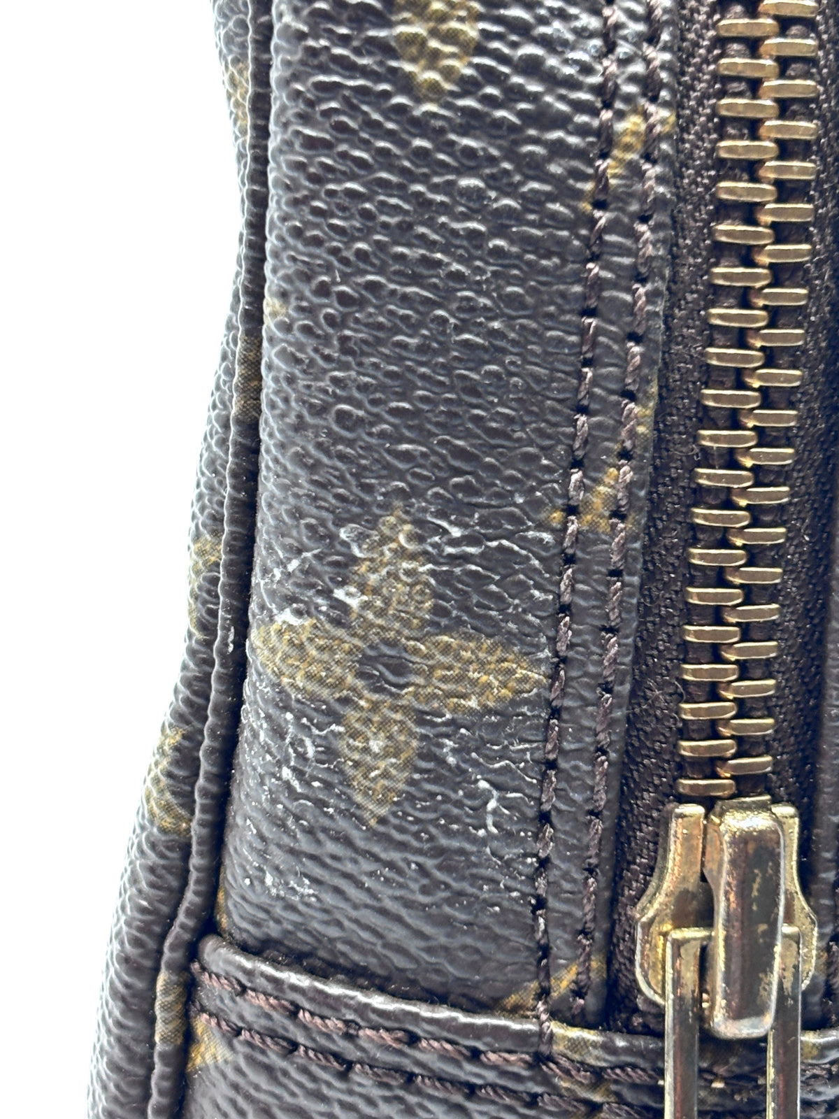 Close-up of Posh Purse Co. preloved Louis Vuitton Trousse Toilette 23 showing monogram canvas and metal zipper detail.