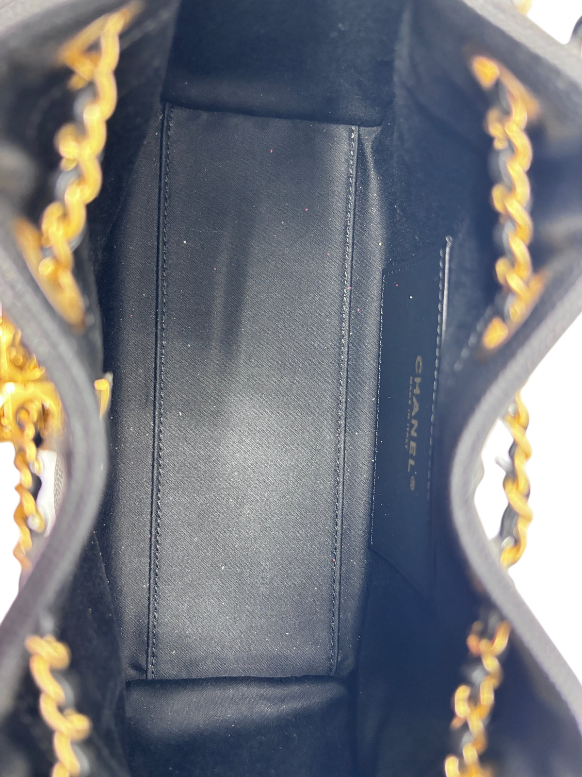 Interior view of a black Chanel 25 Mini Hobo bag from Posh Purse Co. showing clean lining and gold chain strap detail.