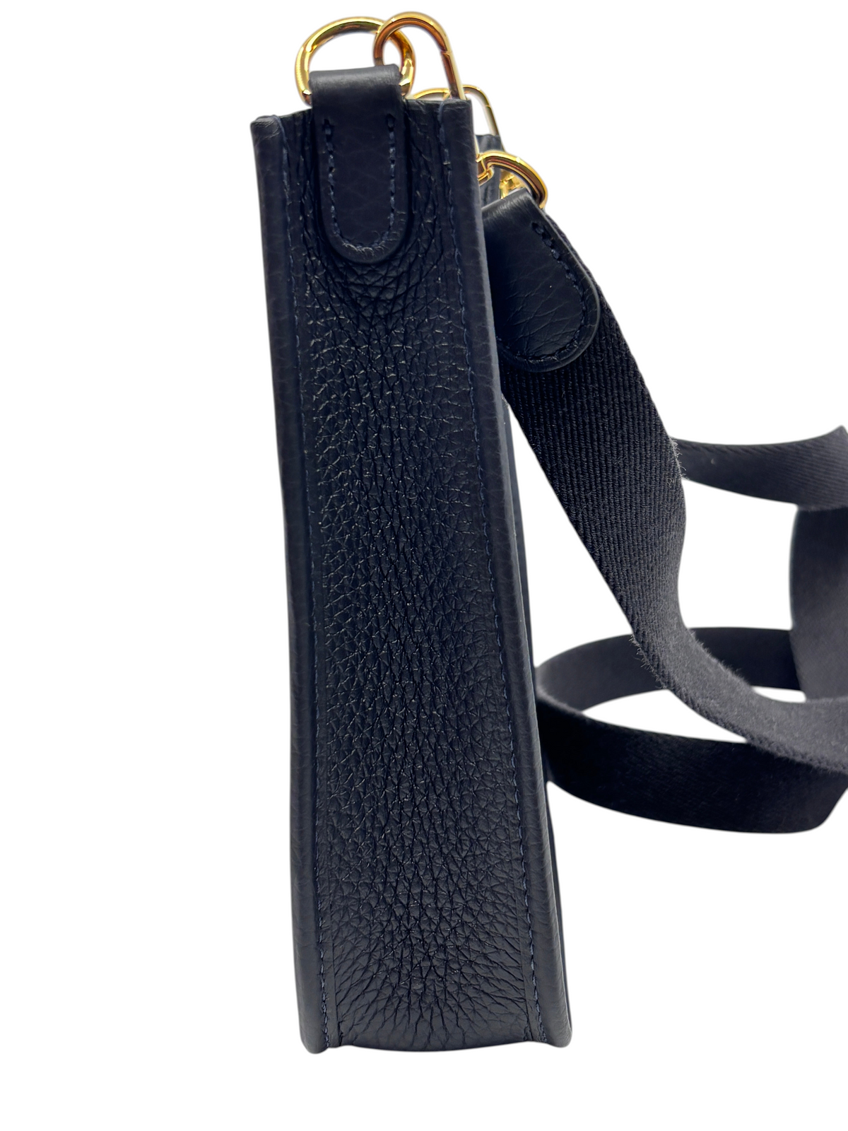 Posh Purse Co. Hermès Evelyne TPM mini crossbody bag in dark leather with gold hardware, side view.