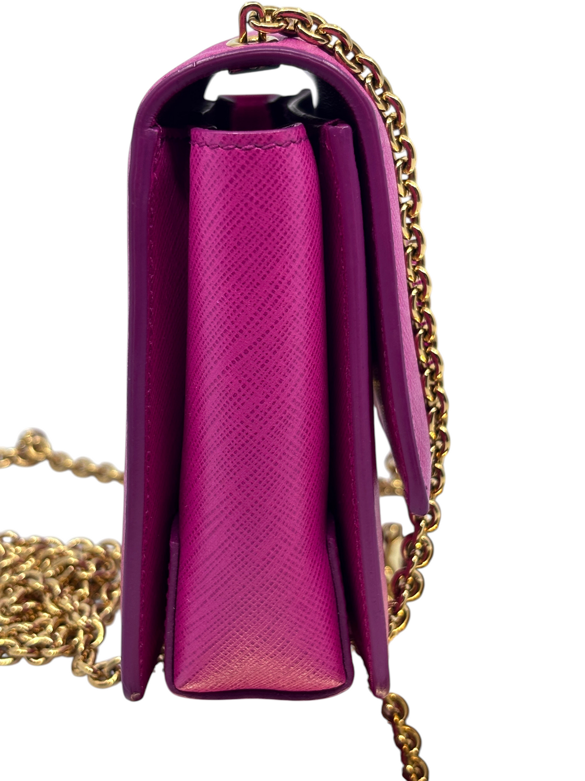Side view of a pink Posh Purse Co. Salvatore Ferragamo Vara Bow crossbody bag with a gold chain strap.