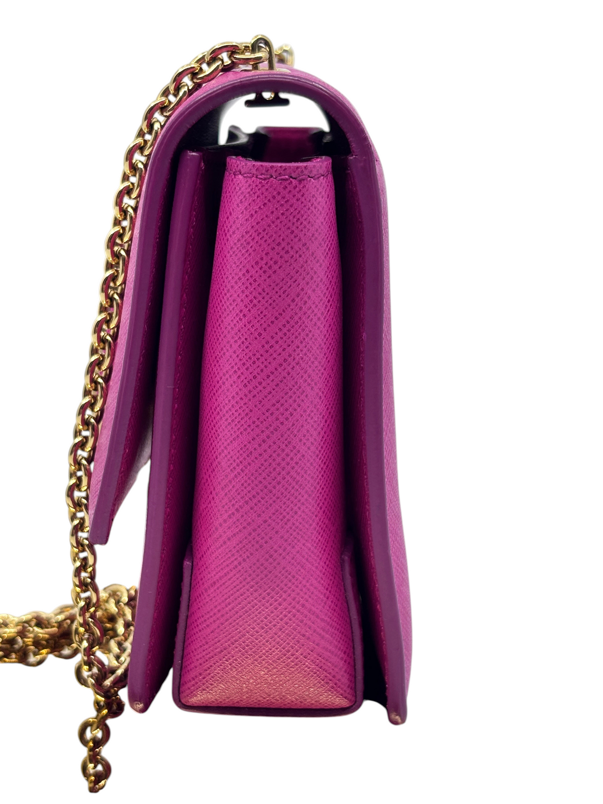 Side view of a pink Salvatore Ferragamo Vara Bow crossbody bag with a gold chain strap from Posh Purse Co.