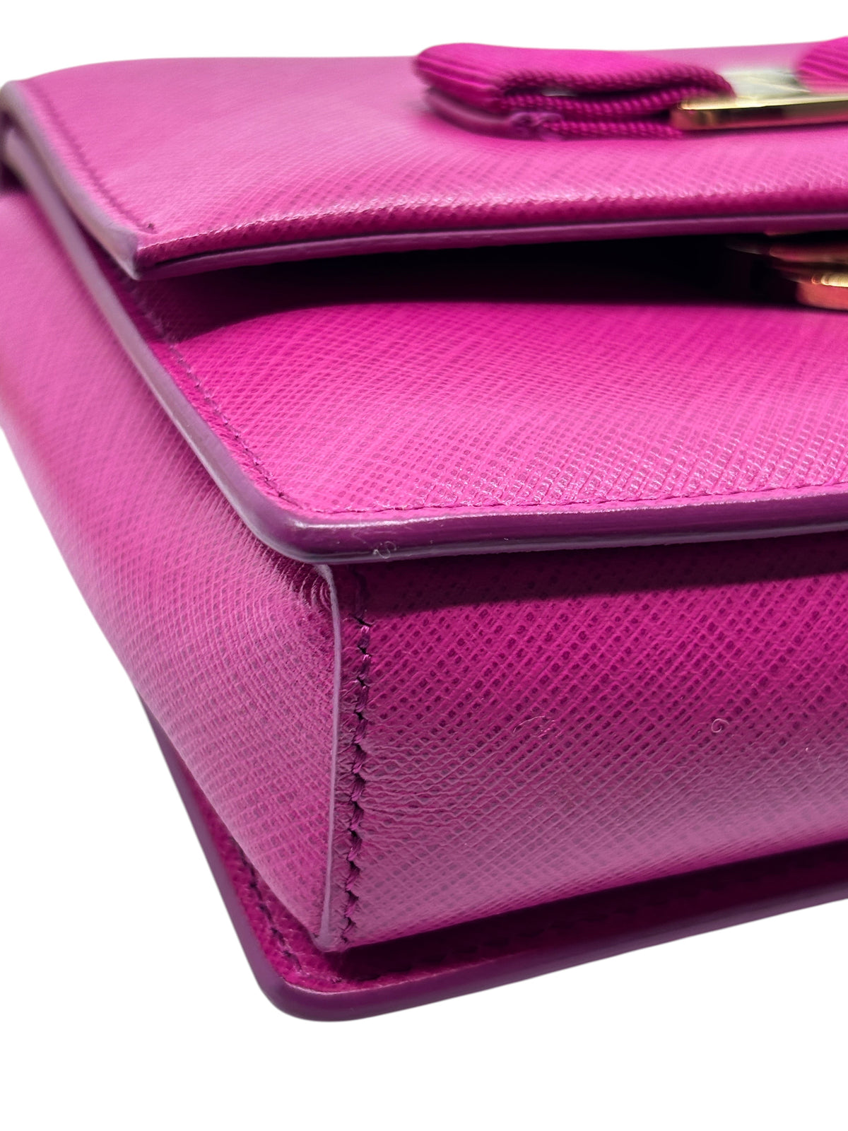Close-up of a pink Posh Purse Co. Salvatore Ferragamo Vara Bow crossbody bag featuring textured leather and gold hardware