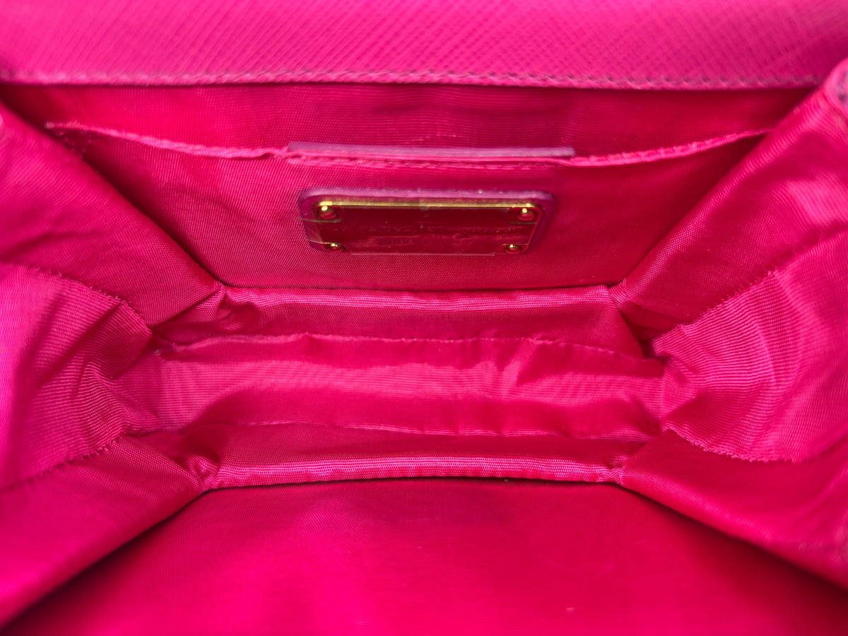 Interior view of a pink Posh Purse Co. Salvatore Ferragamo Vara Bow crossbody bag with gold hardware label