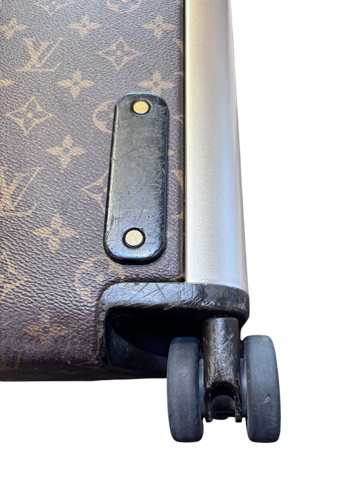 Posh Purse Co Louis Vuitton Horizon 55 rolling suitcase corner detail showing monogram canvas and wheel