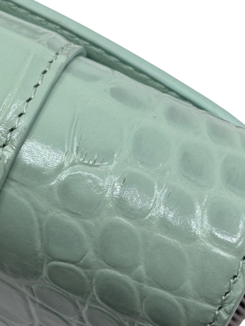 Close-up of Posh Purse Co preloved Balenciaga Hourglass bag in mint green croc-embossed leather showing surface wear.