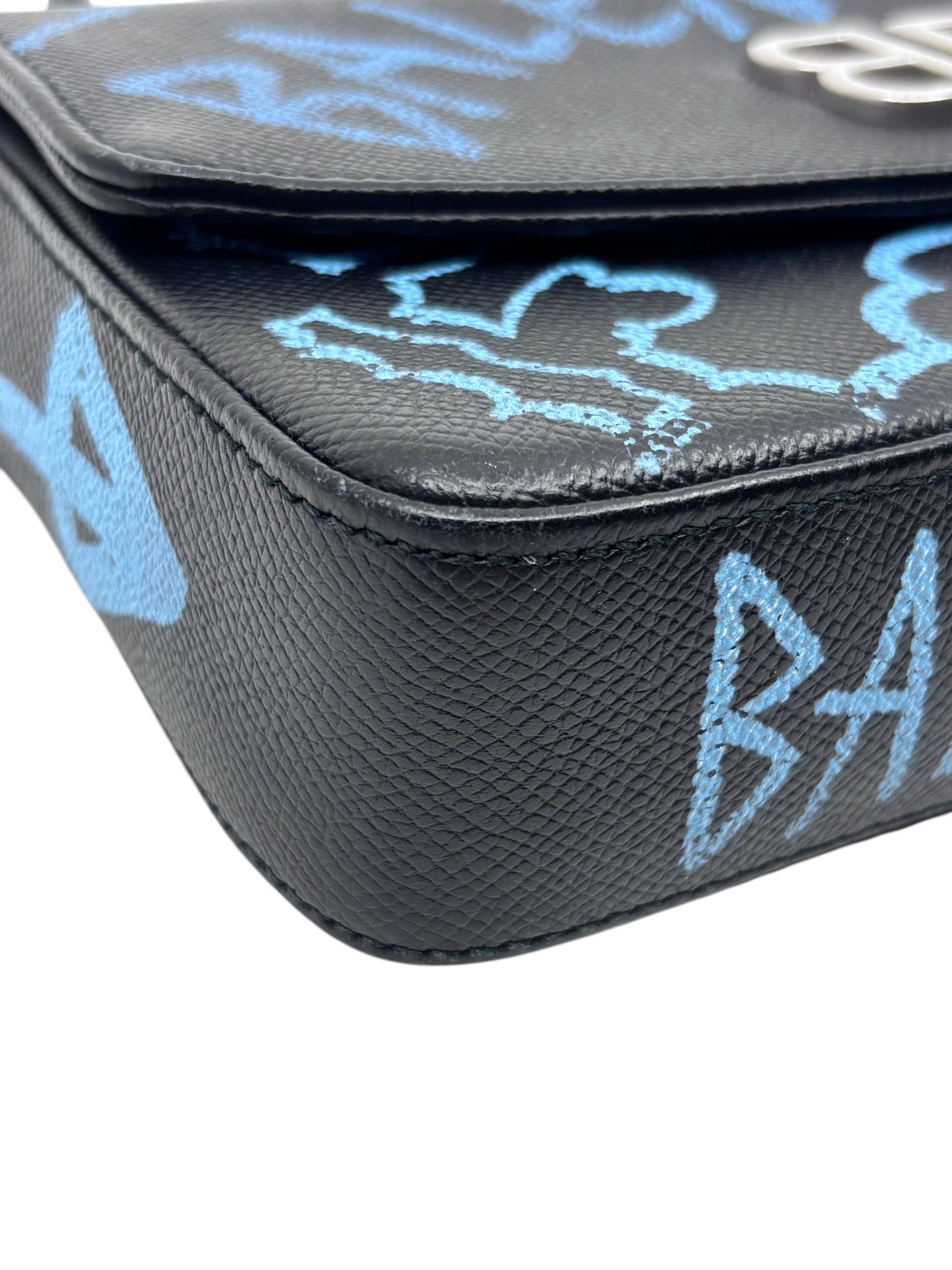 Posh Purse Co black leather Balenciaga wallet on chain featuring blue graffiti logo print and textured finish
