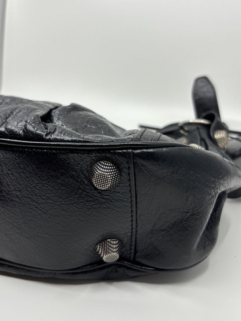 Posh Purse Co. black leather Balenciaga La Cagole shoulder bag with silver stud details and a curved silhouette.
