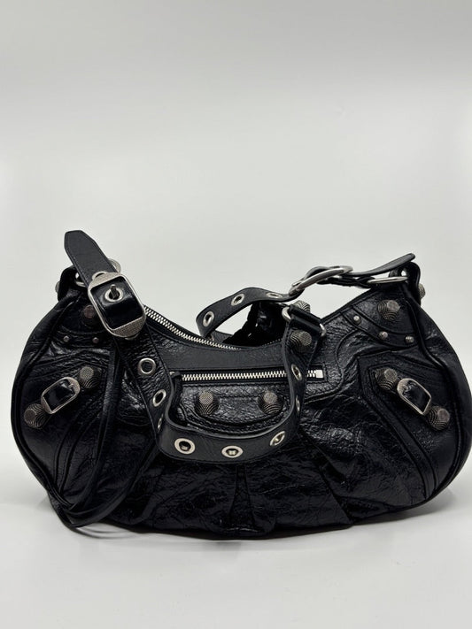 Posh Purse Co. black leather Balenciaga La Cagole shoulder bag with silver studs and buckle details.