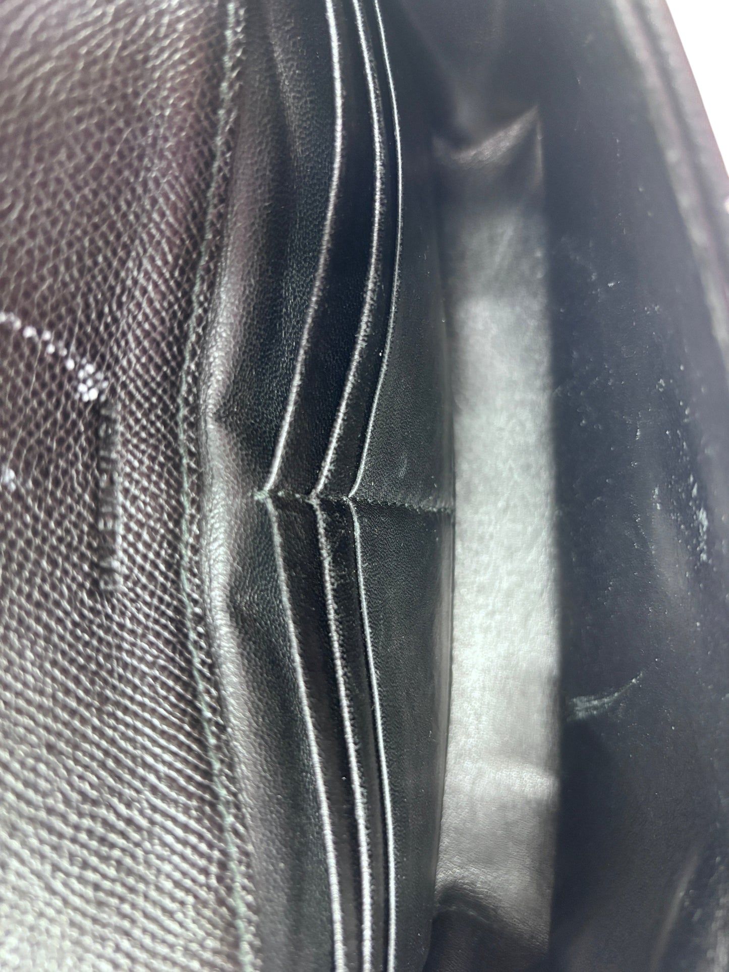 Interior view of a black Posh Purse Co preloved Balenciaga Graffiti wallet on chain showing card slots and lining.