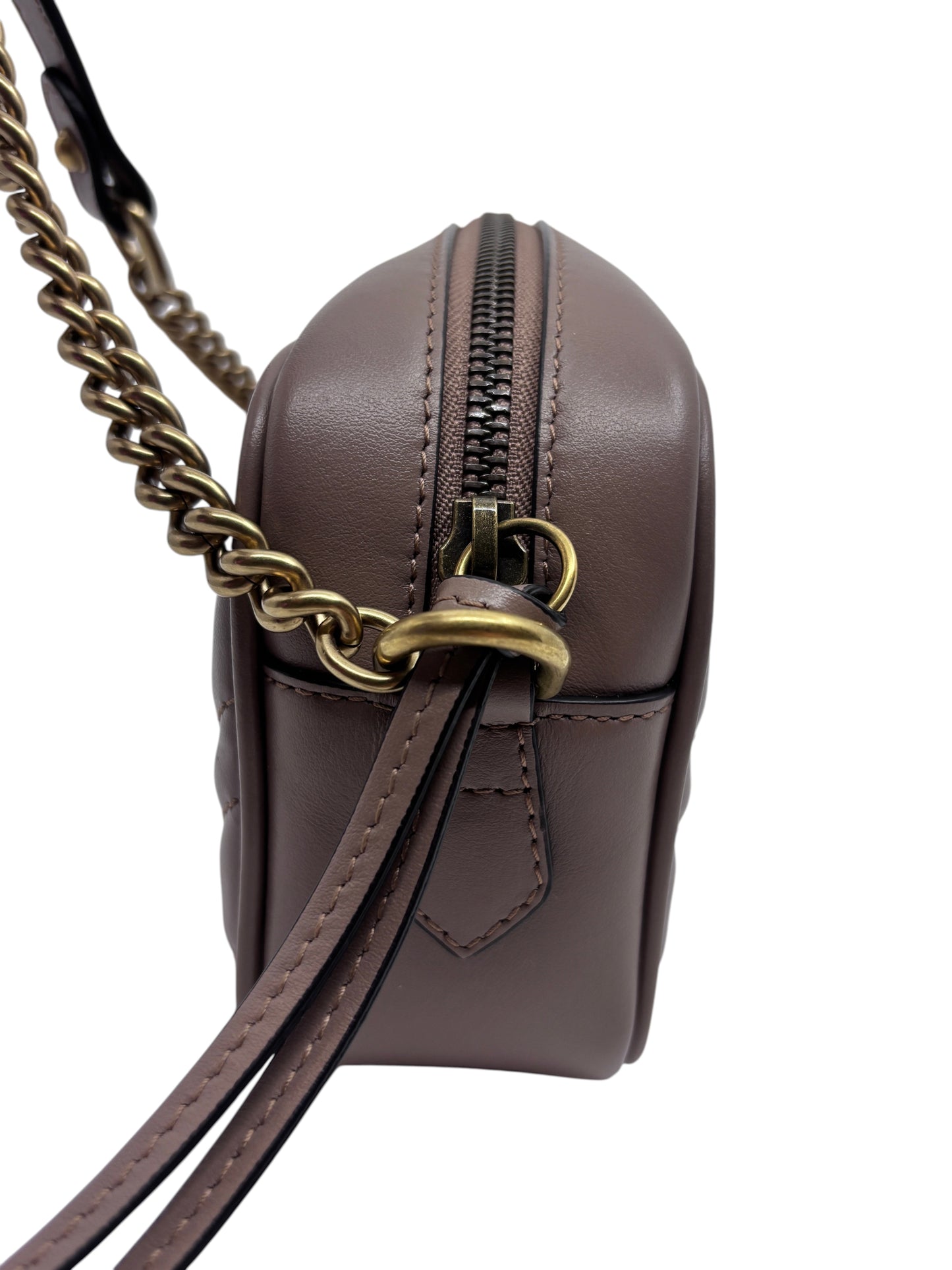 Posh Purse Co. beige Gucci camera bag side view featuring a gold chain strap and zip closure.