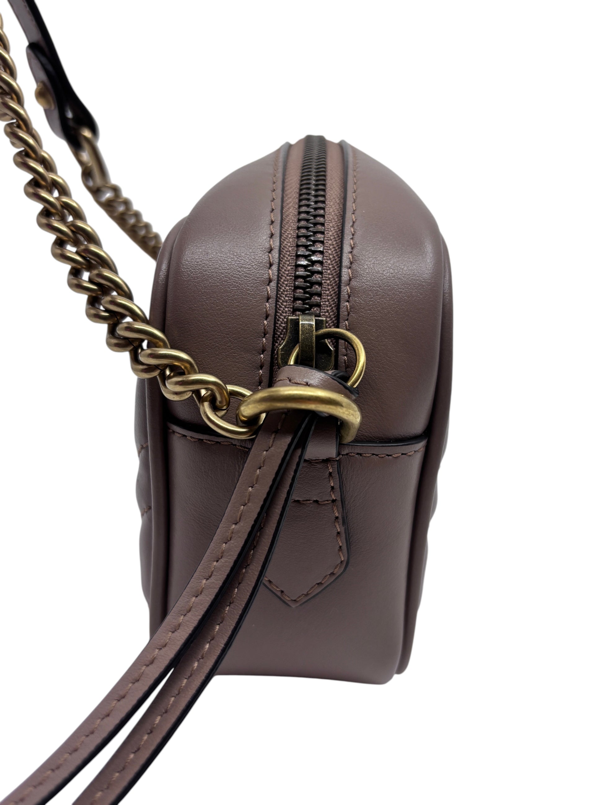 Posh Purse Co. beige Gucci camera bag side view featuring a gold chain strap and zip closure.