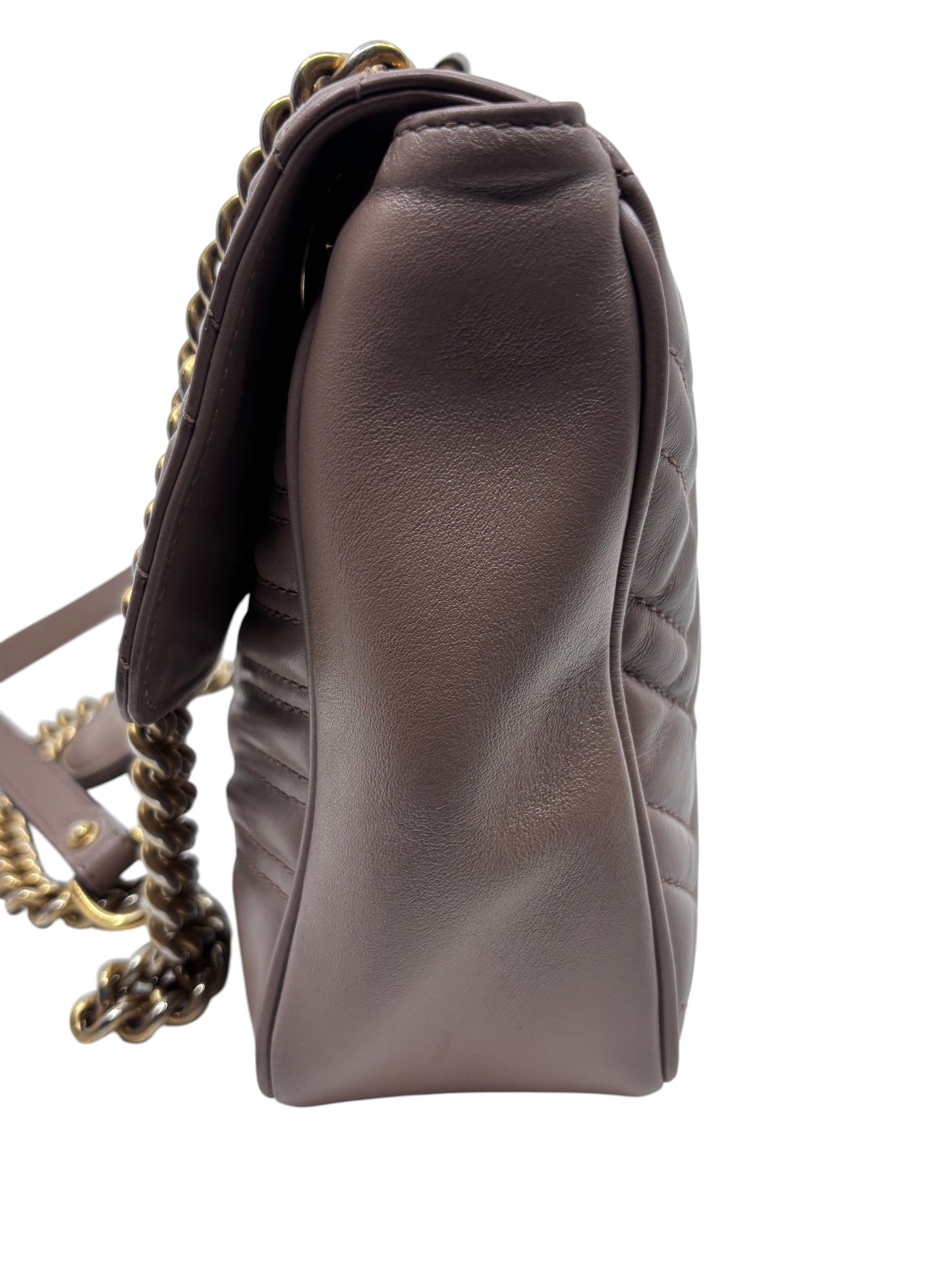 Side view of a beige quilted leather Gucci Marmont shoulder bag with gold chain strap from Posh Purse Co.