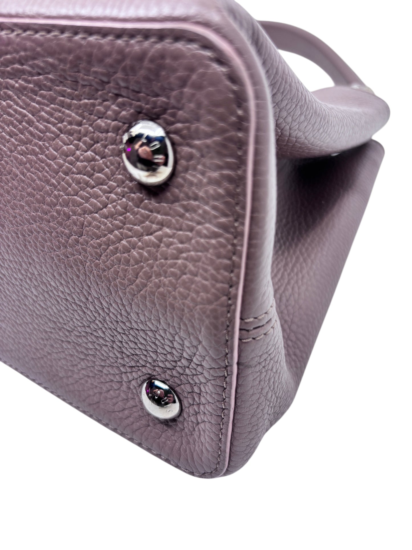 Posh Purse Co beige Louis Vuitton Capucines MM handbag showing textured leather base and silver protective feet