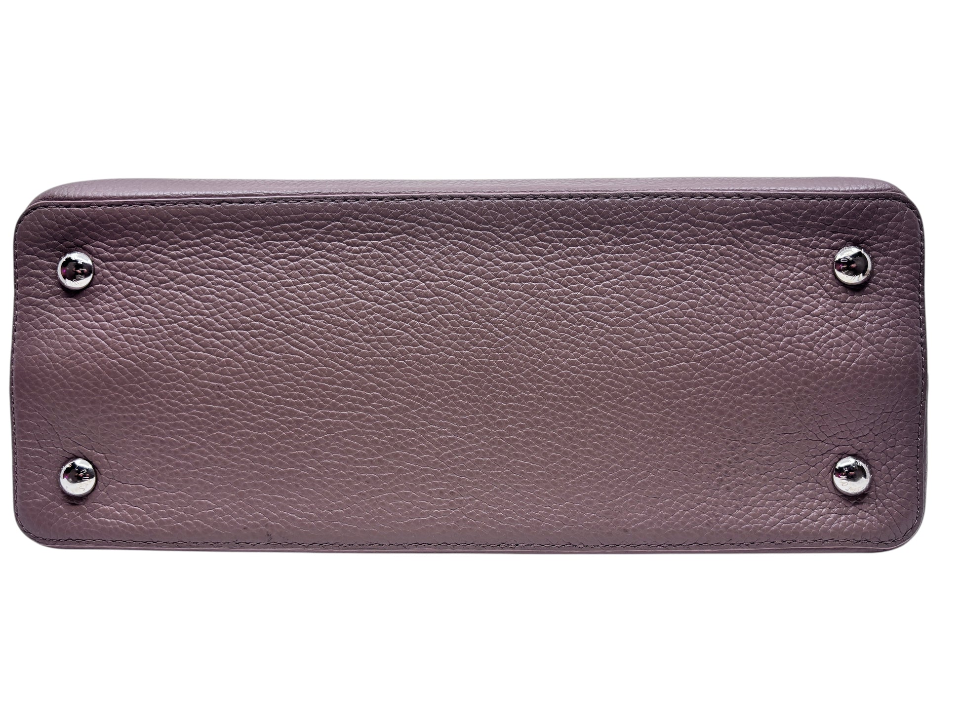 Base of a beige Louis Vuitton Capucines MM handbag from Posh Purse Co featuring protective silver metal feet