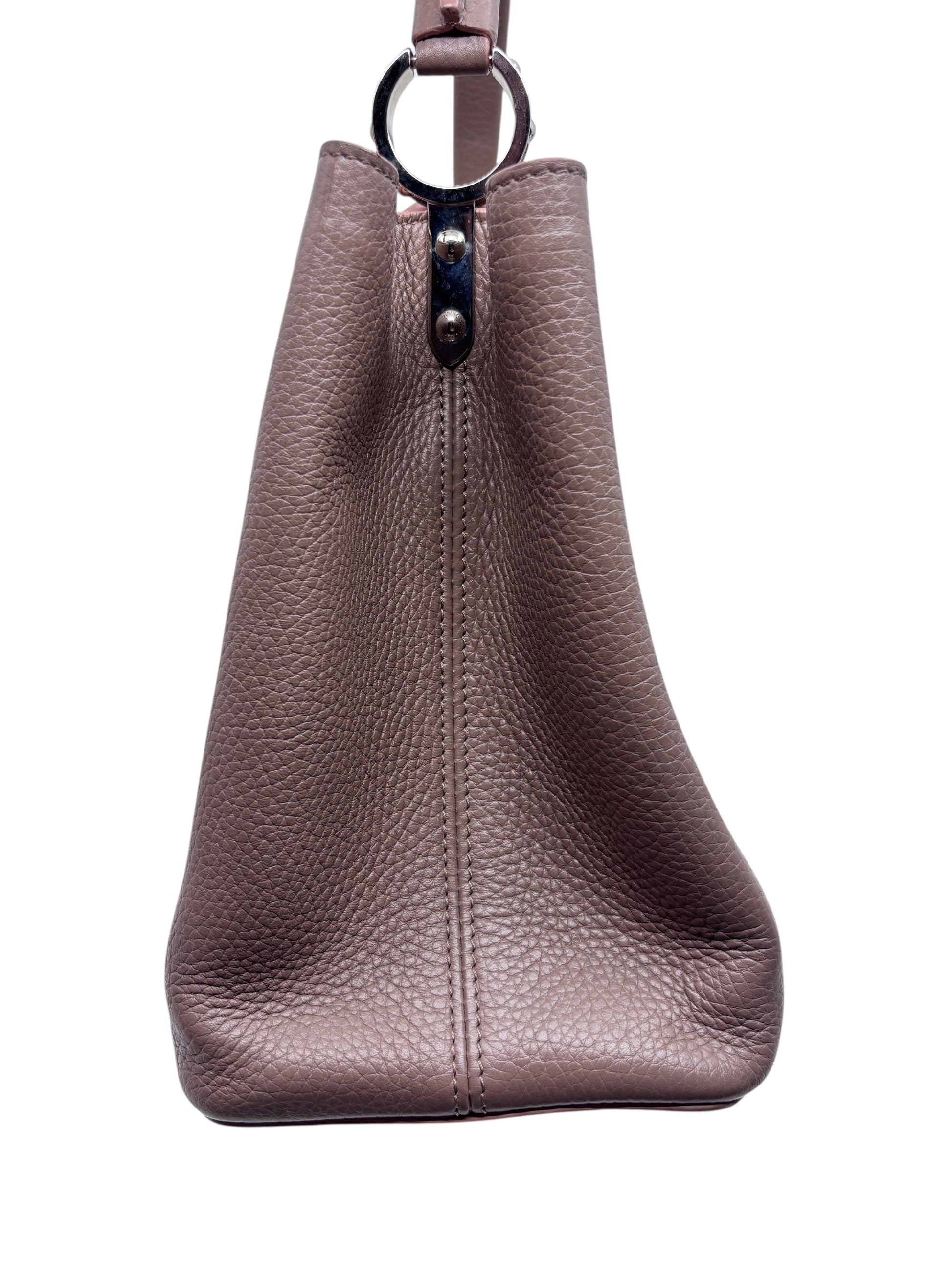 Side view of a beige Posh Purse Co preloved Louis Vuitton Capucines MM handbag in textured leather with silver hardware.