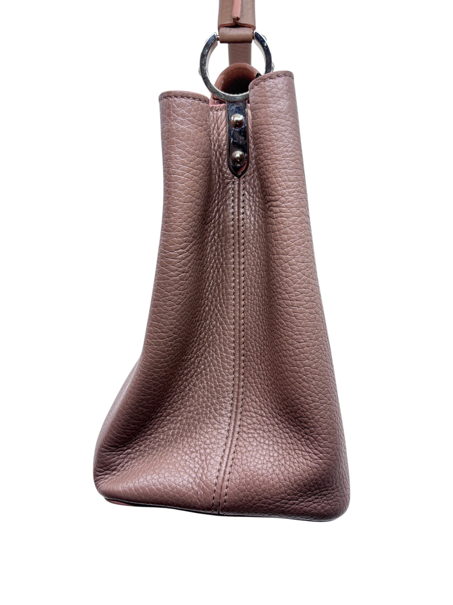 Side view of a beige Posh Purse Co Louis Vuitton Capucines MM handbag showing textured leather and silver hardware