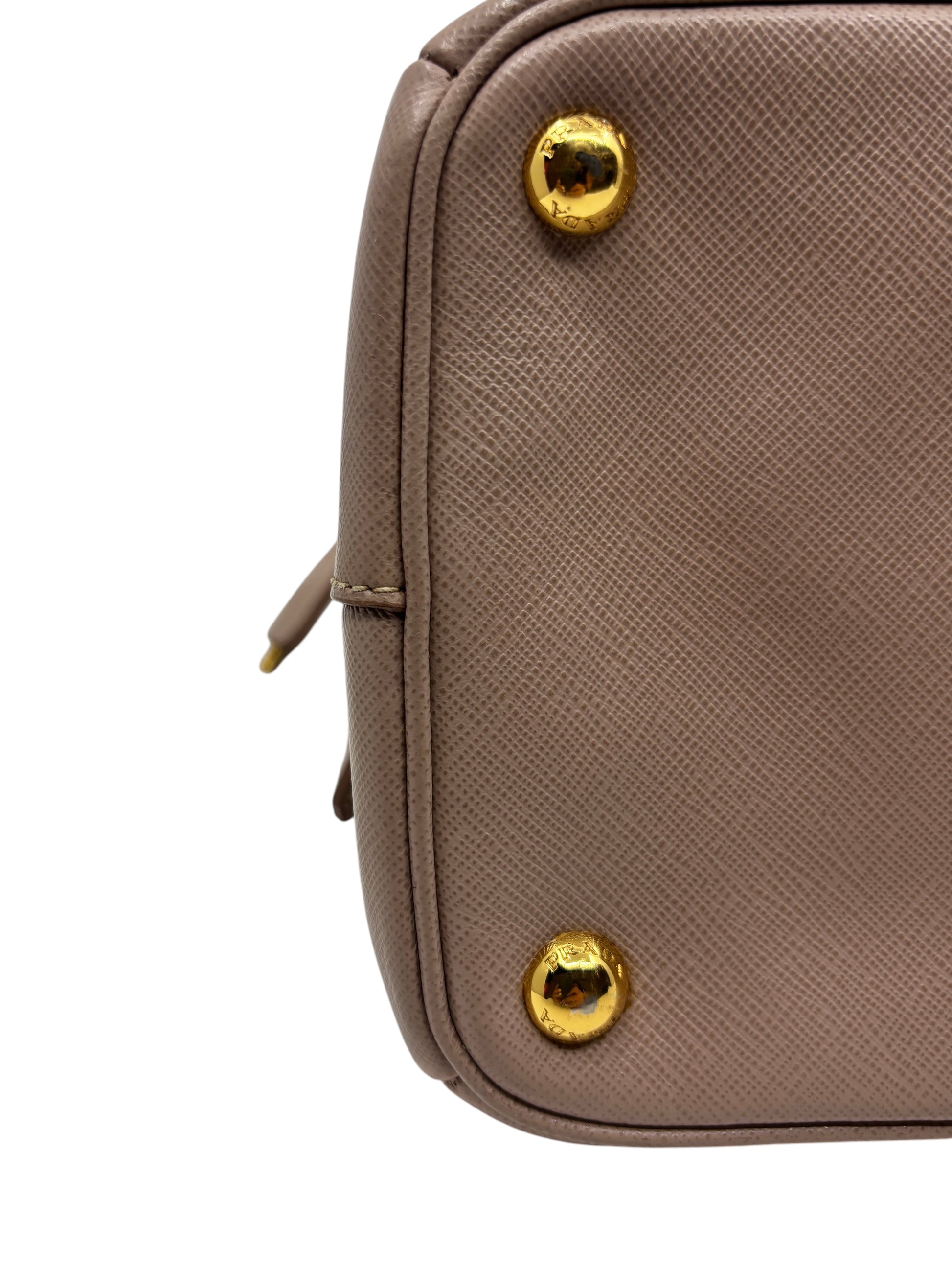 Posh Purse Co. beige Saffiano leather Prada tote bag base detail with polished gold-tone protective metal feet