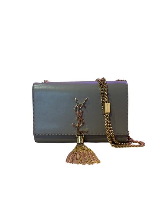 Posh Purse Co. beige leather Saint Laurent crossbody bag with gold tassel and chain strap.