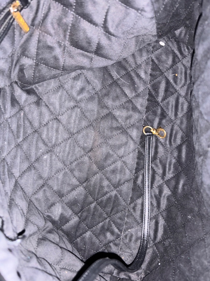 Posh Purse Co. Large Black Chanel 22 bag in shiny calfskin leather with gold hardware and diamond quilting.