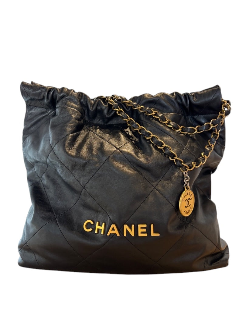 Posh Purse Co. Large Black Chanel 22 bag in shiny calfskin leather with gold hardware and chain detail.