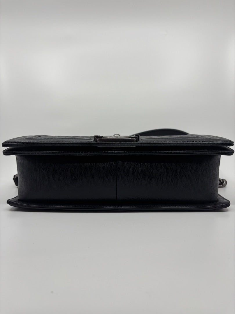Posh Purse Co. Large black Chanel Boy Bag in caviar leather with signature hardware and chain strap.