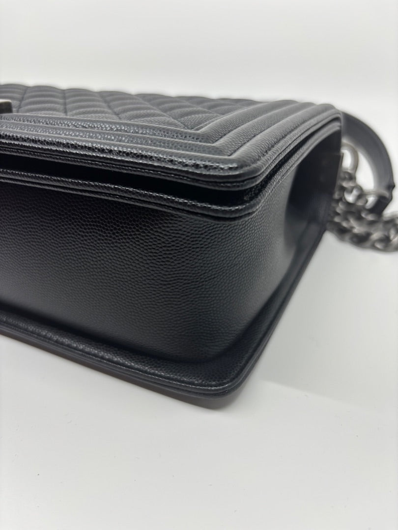 Posh Purse Co. large black Chanel Boy Bag in caviar leather with signature quilting and chain strap.