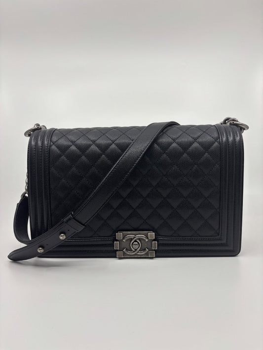 Posh Purse Co. large black Chanel Boy Bag in caviar leather with signature quilting and chain strap.