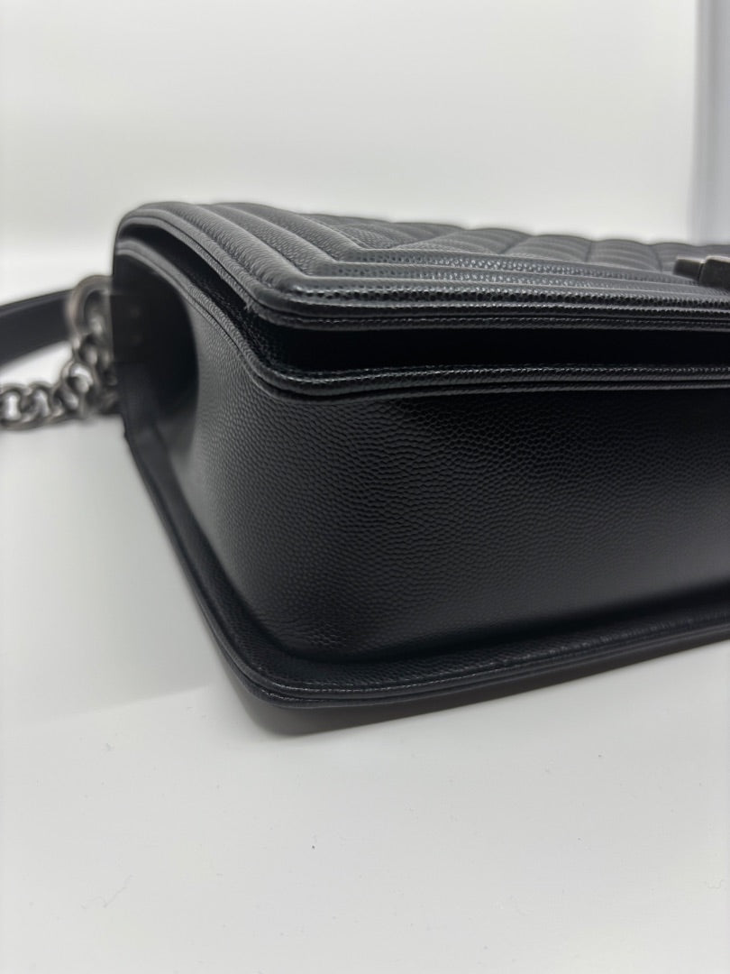 Posh Purse Co. black Chanel Boy Bag in large size, crafted from caviar leather with signature chevron quilting and chain strap.