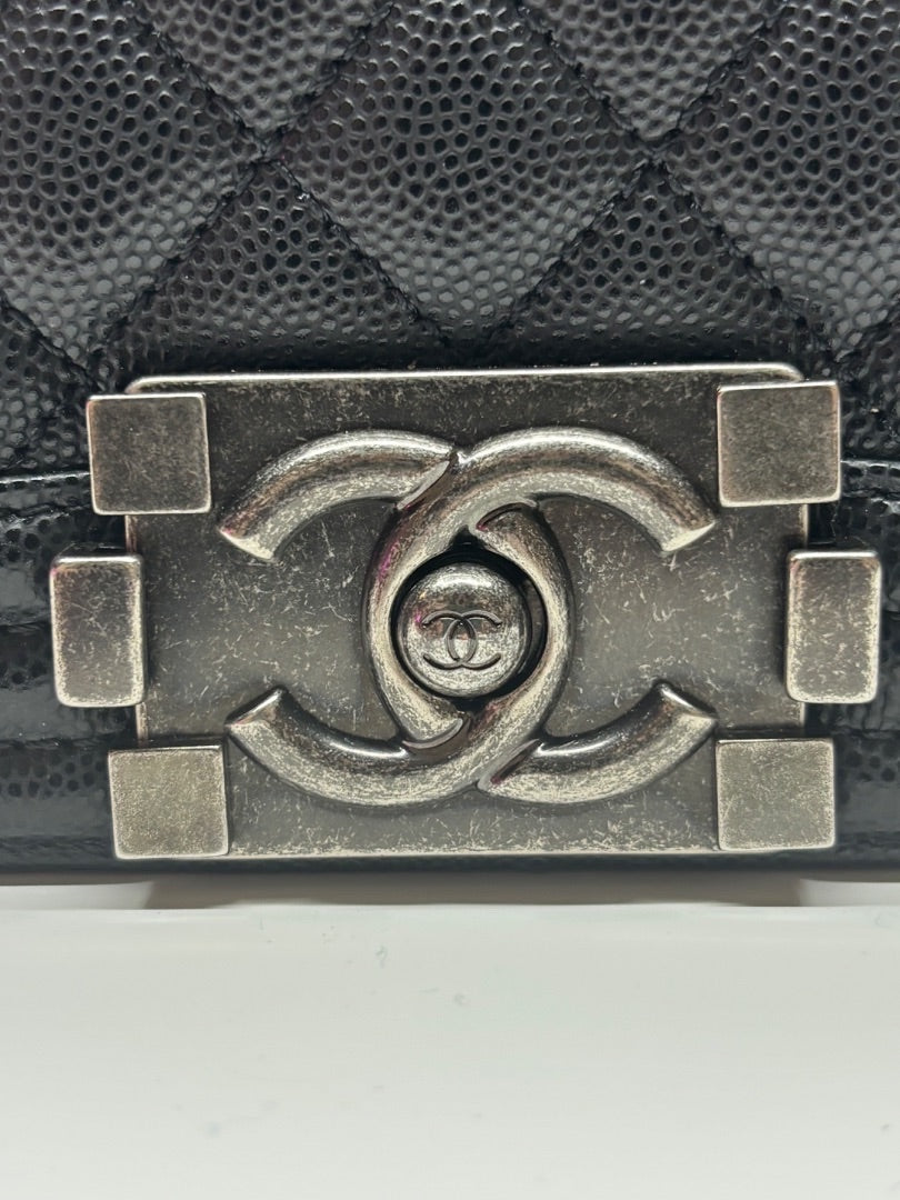 Posh Purse Co. black Chanel Boy Bag in large size, crafted from caviar leather with signature interlocking CC logo hardware.
