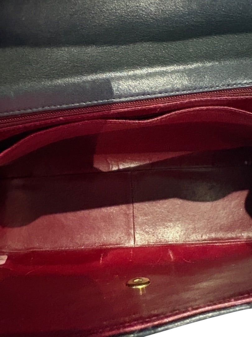 Posh Purse Co black Chanel calfskin jumbo flap bag interior with red lining and gold hardware closure.