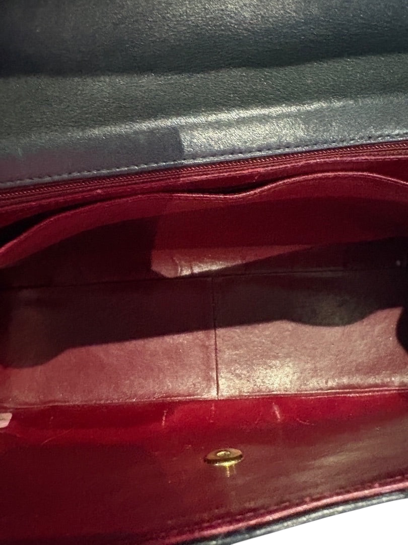 Posh Purse Co black Chanel calfskin jumbo flap bag interior with red lining and gold hardware closure.