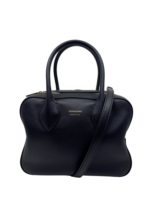 Posh Purse Co. black Ferragamo triple zip handbag with structured leather silhouette and gold tone logo detailing.
