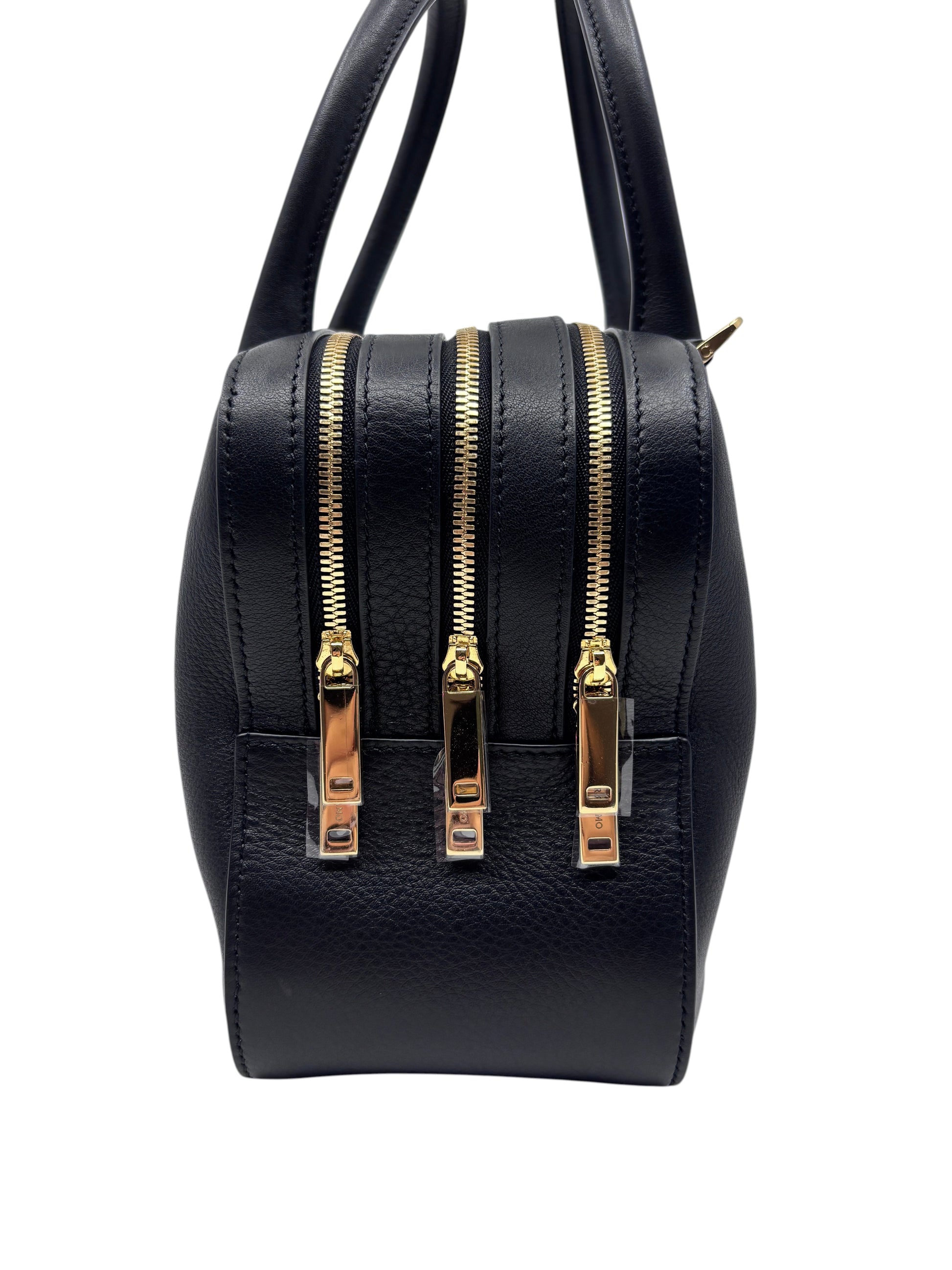 Posh Purse Co. black Ferragamo triple zip handbag with gold hardware and structured leather design