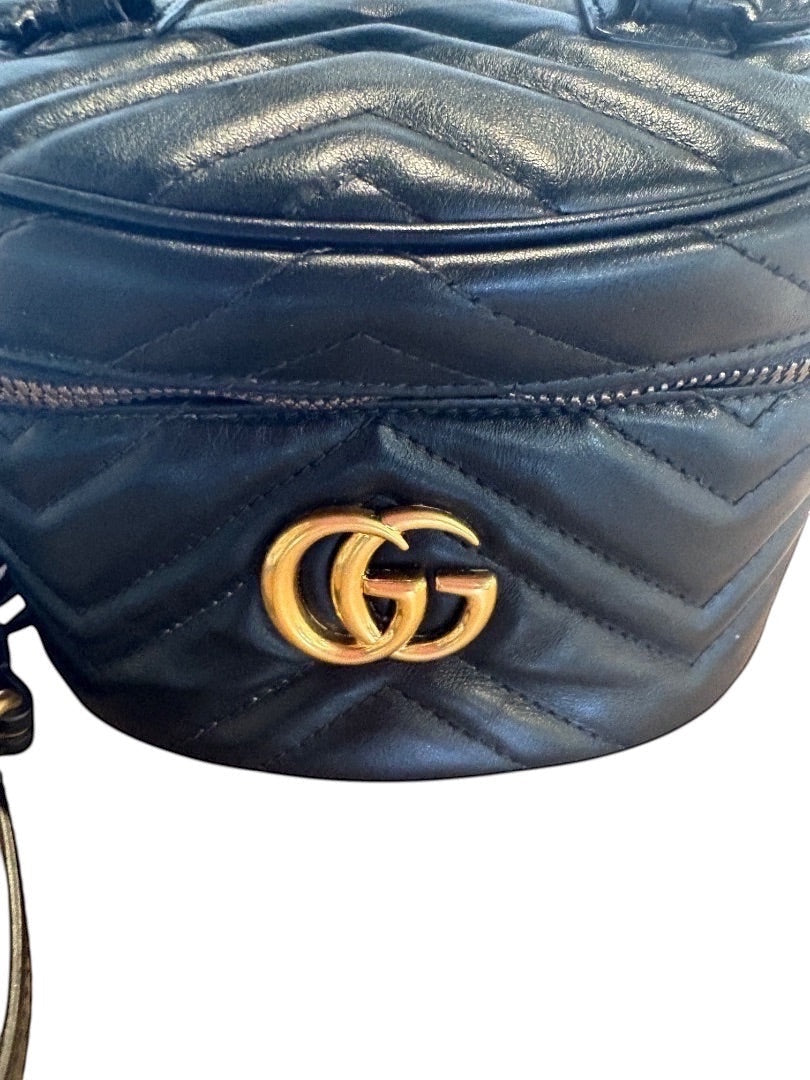 Posh Purse Co black Gucci GG Marmont mini backpack in matelassé chevron leather with antique gold-tone GG logo.