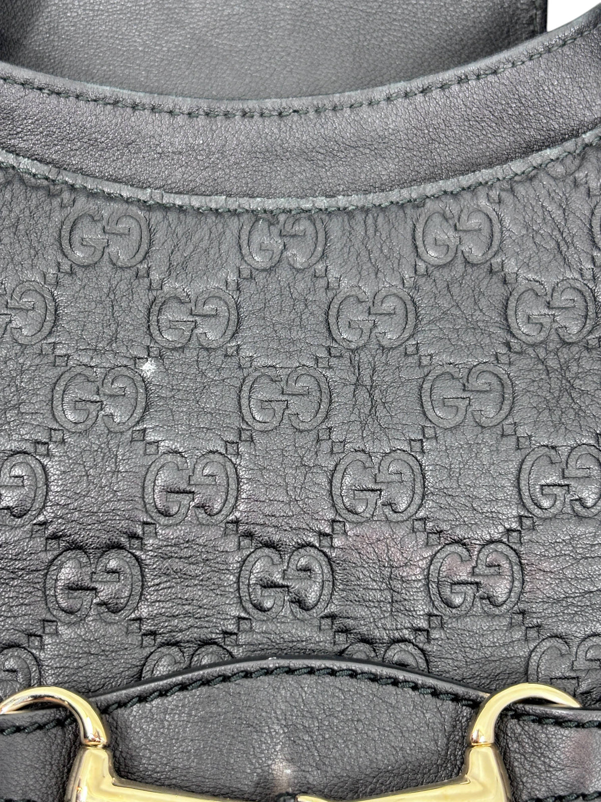 Posh Purse Co. black leather Gucci Horsebit 1955 hobo bag featuring embossed GG monogram pattern and gold hardware