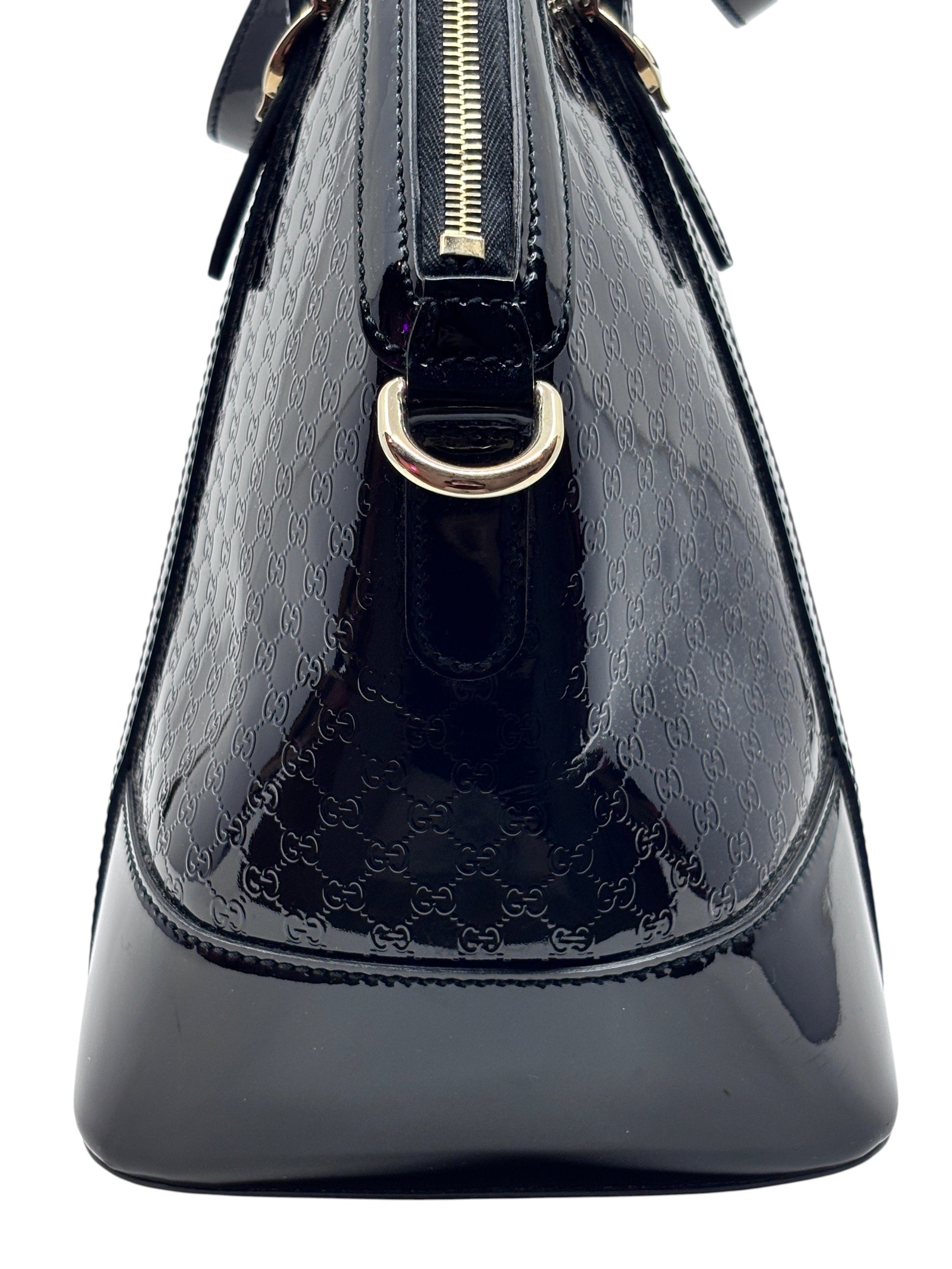 Posh Purse Co black Gucci Micro Guccissima leather handbag featuring the iconic embossed GG pattern and gold hardware.