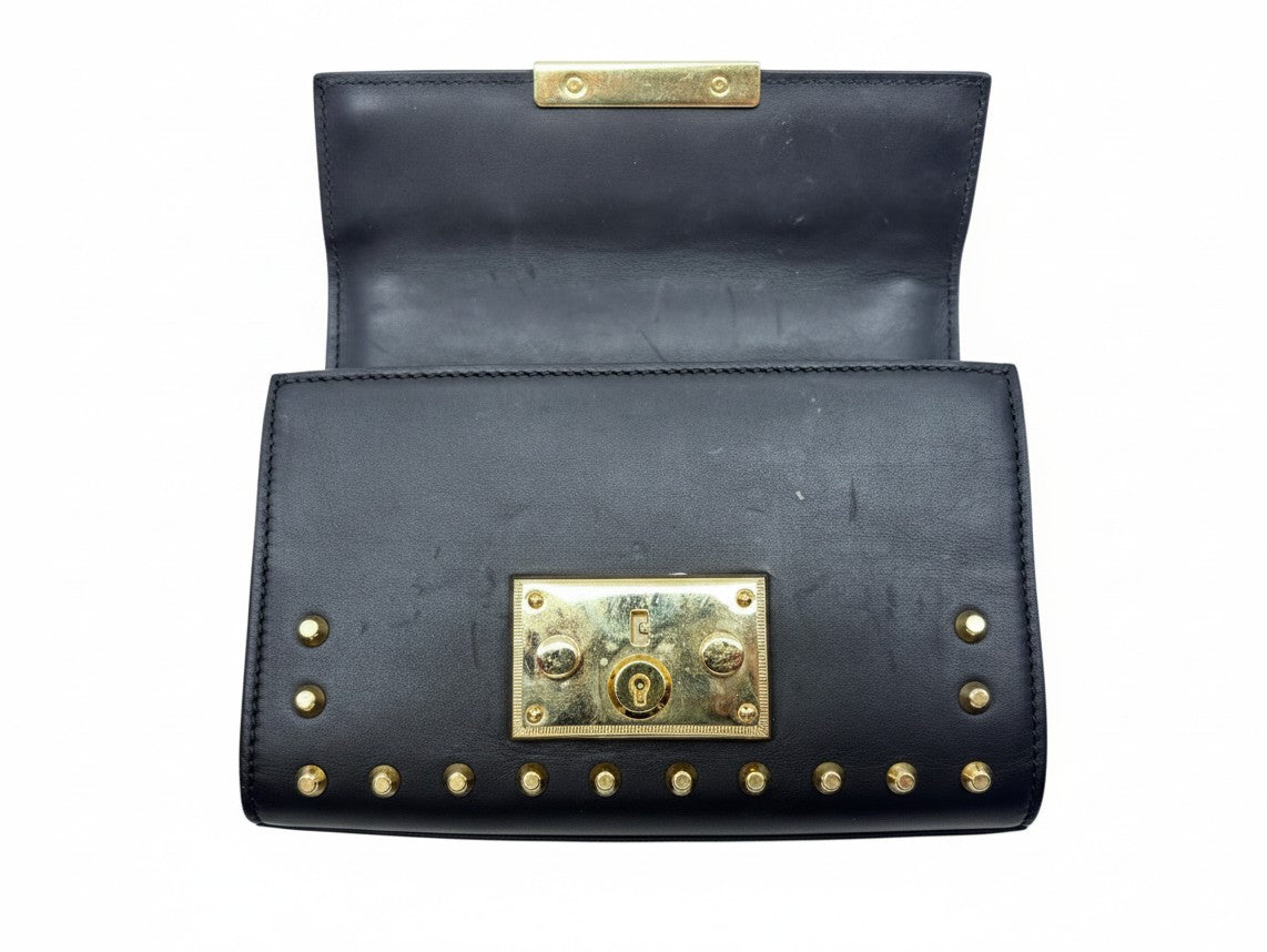 Posh Purse Co black Gucci shoulder bag with gold-tone hardware and pearl embellishments on a white background