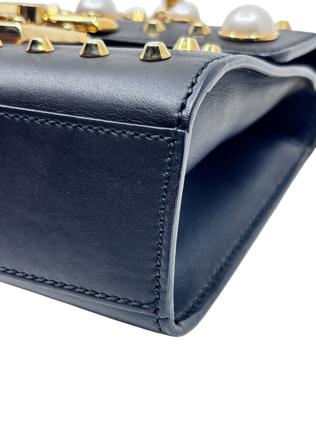 Posh Purse Co black leather Gucci shoulder bag featuring gold studs and pearl embellishments on the flap