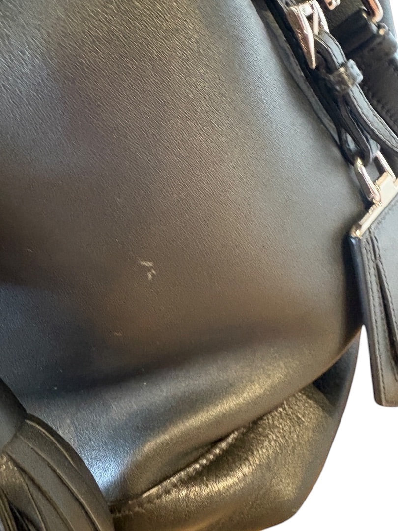 Posh Purse Co. black leather Prada bucket bag with silver hardware and a small scuff mark on the front.