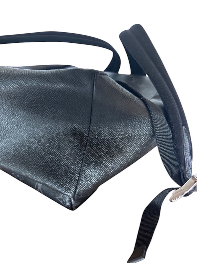 Posh Purse Co black Louis Vuitton Discovery backpack in coated canvas with leather trim and adjustable shoulder straps.